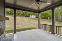 The other side of the fireplace is a more private space just outside Owner’s Suite.  Totally private back porch backs to your own wooded hillside