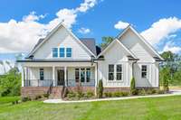 We love the front elevation of this home! The brick and creamy white details of the exterior give this a classic clean modern farmhouse look. Craftsworth Builders really knocked this one out of the park!