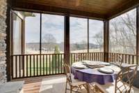 Screened porch, off the master bedroom, with Fireplace. What a great space to enjoy breakfast.