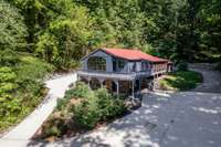 ANOTHER FRONT VIEW WITH CONCRETE CIRCLE DRIVEWAY.