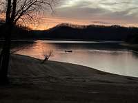 BOATER ON LAKE AT DUSK