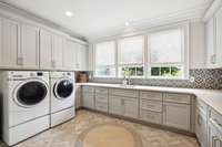 Huge laundry room, #1 of two in the home, washer and dryer remain. Tons of storage and cainetry