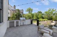 Outdoor kitchen with Wolf gas grill, SubZero ice maker #2, mini fridge and wood burning fireplace.