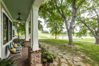 From the front porch, take in the breathtaking views of the sprawling farmland and the large, picturesque pond.