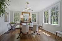 Formal, bright Dining Area with Crown Molding, Stucco Walls, and Gleaming Hardwoods.