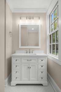 The elegant vanity in the en suite bath offers ample space and stylish design, making your daily routine a pleasure. With modern fixtures, dazzling marble countertops, and plenty of storage, it's both functional and beautiful.