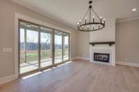 Beautiful shiplapped fireplace adorned with a handmade wooden mantle and herringbone tile.