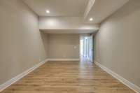 Media room in basement exits to hallway and back to basement living area. This space is perfect for in-laws, teenagers, guests, and more!