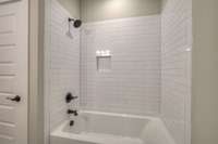 Beautiful custom tiled shower in bedroom 4.