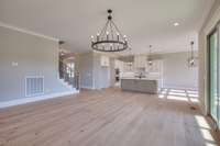 The living room and open floor plan opens to the heart of the home - the kitchen!