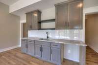 Fully custom basement wet bar with leathered granite countertops!