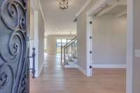 Custom double iron doors greet you and your guests in this entry foyer.