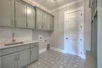 We LOVE this laundry room! Complete with laundry sink, drop zone, and cubbies, it is also the gateway to the basement garage and more living areas including a storm room!