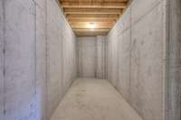 Fully poured concrete area is perfect for a storm room, storage, wine cellar and more!