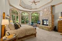 Expansive Primary Bedroom on main level with vaulted ceiling and another amazing wall of windows.