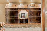 Behind a double paned, thermal paned glass wall is a 3,500+ bottle capacity breathtaking wine cellar with custom redwood wine racking to include large formats of all sizes.