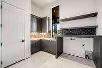 Primary Laundry room with sink - located on the primary suite wing of the home.