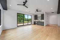 Recreation Room with collapsable sliding doors leading the large upper deck with views of the side yard, guest house, pool, putting green and backyard.