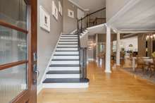 A grand staircase and open foyer greets you as you enter 525 Five Oaks Blvd.