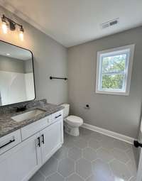 Upstairs bath with tile flooring