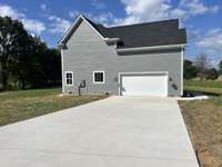 2 Car side entry garage with concrete driveway