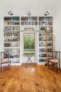 Calling all bookworms! Enjoy a moviesque library space complete with a sliding ladder to access the top shelves. 5901 Givens Rd Lascassas, TN 37085