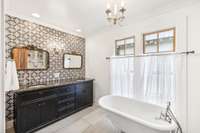 The stunning bathroom showcases double vanities with an adorable accent wall, tile flooring, and a soaking bathtub with a detachable spray nozzle.  5901 Givens Rd Lascassas, TN 37085