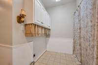 Laundry nook — storage closet behind curtain