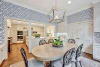 Charming breakfast room off kitchen with high ceilings and custom brass and navy lantern.