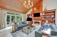 Family Room: expansive space with double french doors leading to the patio. Gas fireplace, built in shelving and a powder room complete this space.