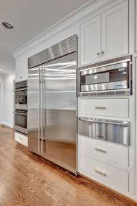 Subzero fridge, built in microwave and warming drawer, GE monogram double ovens.