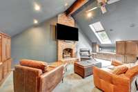 Bonus Room with gas fireplace and built in shelving and office space.  Vaulted ceilings, ceiling fan and two skylights.