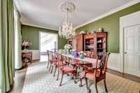 Stunning dining room with two sets of french doors and swinging butler's door leads to kitchen.  The Bacarrat chandelier sparkles and shines!