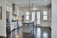 Kitchen with island and French doors that open to the back deck for easy entertaining.