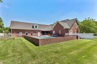 Brick knee wall surrounding pool.