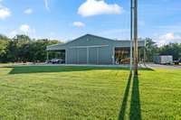 Detached workshop/garage/barn. Plenty of room in this 40x60 space with two 20x60 lean-tos. Bay door is 13'6" tall.