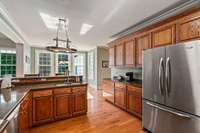 Plenty of space to work in this open and airy kitchen. So many windows to enjoy the outside views.