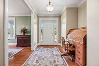 Wide foyer with beautiful crown molding opens up to the formal dining room.