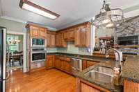 Dream kitchen with oak cabinets, granite counters and a gas cooktop.