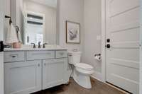 Powder Room with access door to the back covered porch - perfect for your future pool!