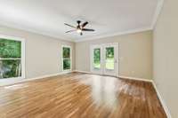 Primary Suite looking out toward backyard.  French doors lead to back deck.