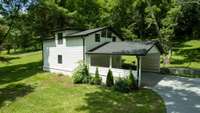 Carport and garage with upstairs studio apartment.