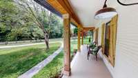 Have a seat and enjoy the sounds of nature on this beautiful covered front porch.