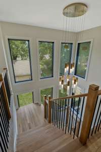 Beautiful wall of windows frame to staircase allowing for tons of natural light