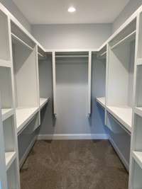 Large walk-in closet with custom shelves