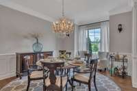 Another view of the dining room, which also features a seating area and space for a china cabinet or buffet.