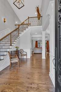 Step inside to a light filled, 2-story entry way open to the formal dining room, living room & front staircase w/ iron railing & hardwood treads. Gleaming oak sand-and-finish hardwood floors w/ walnut stain throughout all living areas on main floor!