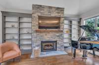 Grand stacked stone gas fireplace with built in shelves and cedar mantle. Wall switches installed for both fireplaces!