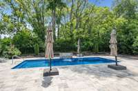 This saltwater in-ground fiberglass pool makes summers in Tennessee splendid! Pool decking consists of travertine pavers.