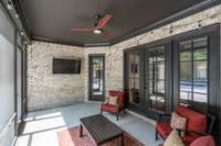 Screened in porch welcomes lounging by the pool in the shade.